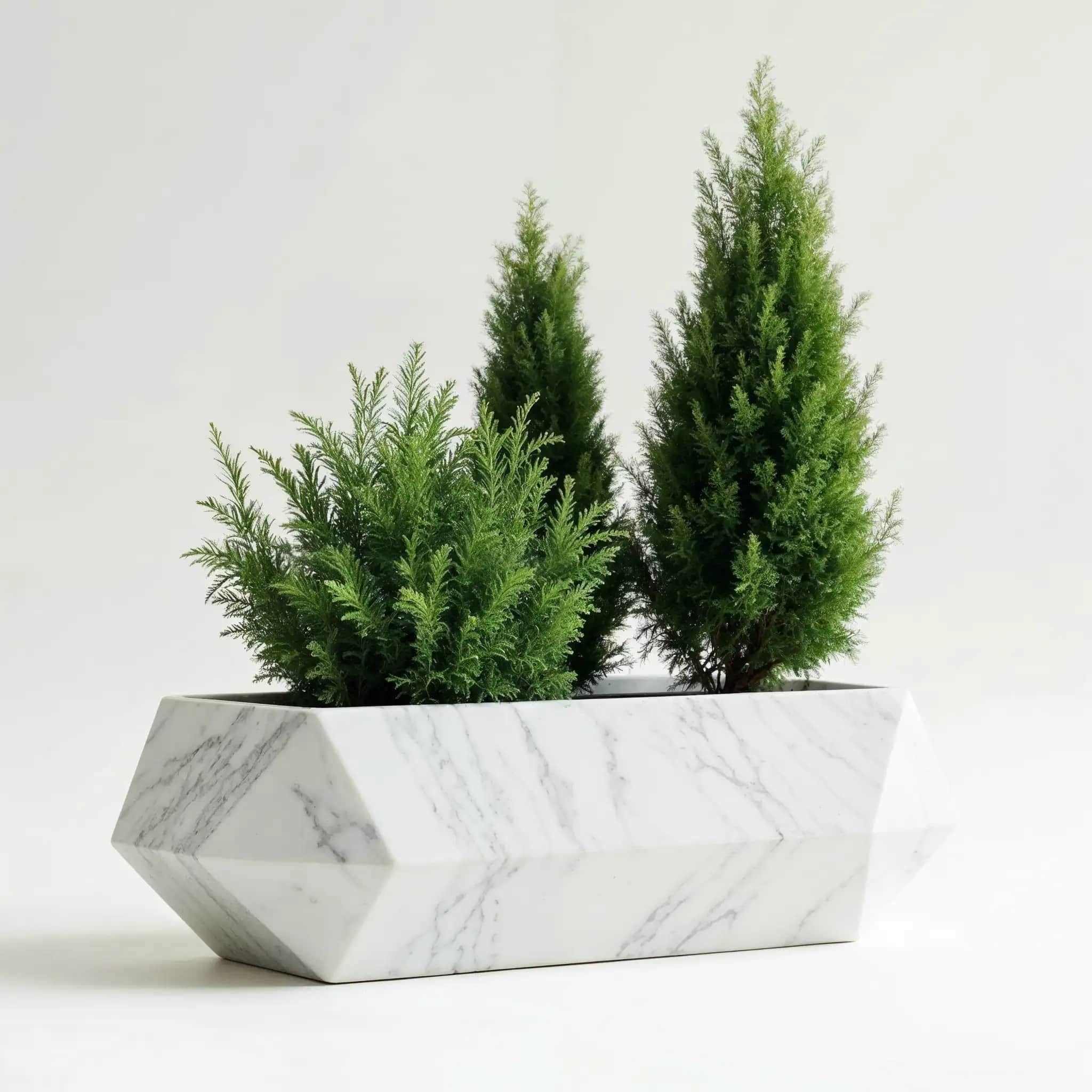 A faceted rectangular planter in white marble