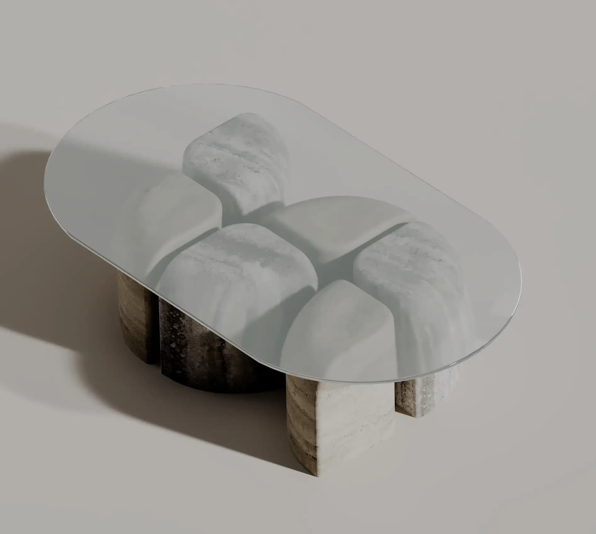 Tesserae coffee table with a rounded glass top over four sculpted marble blocks