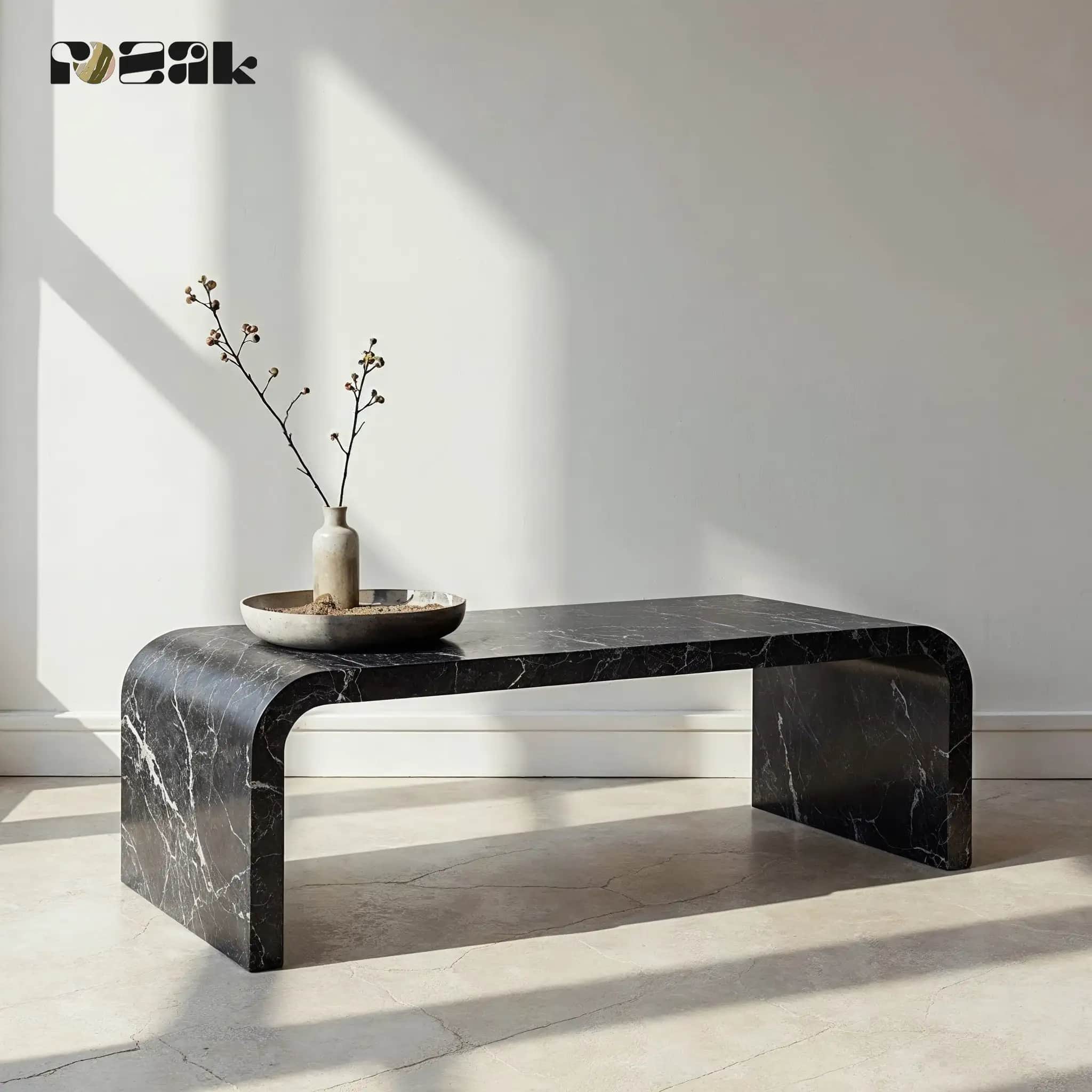 A waterfall-edge coffee table in Nero Marquina marble with white veining