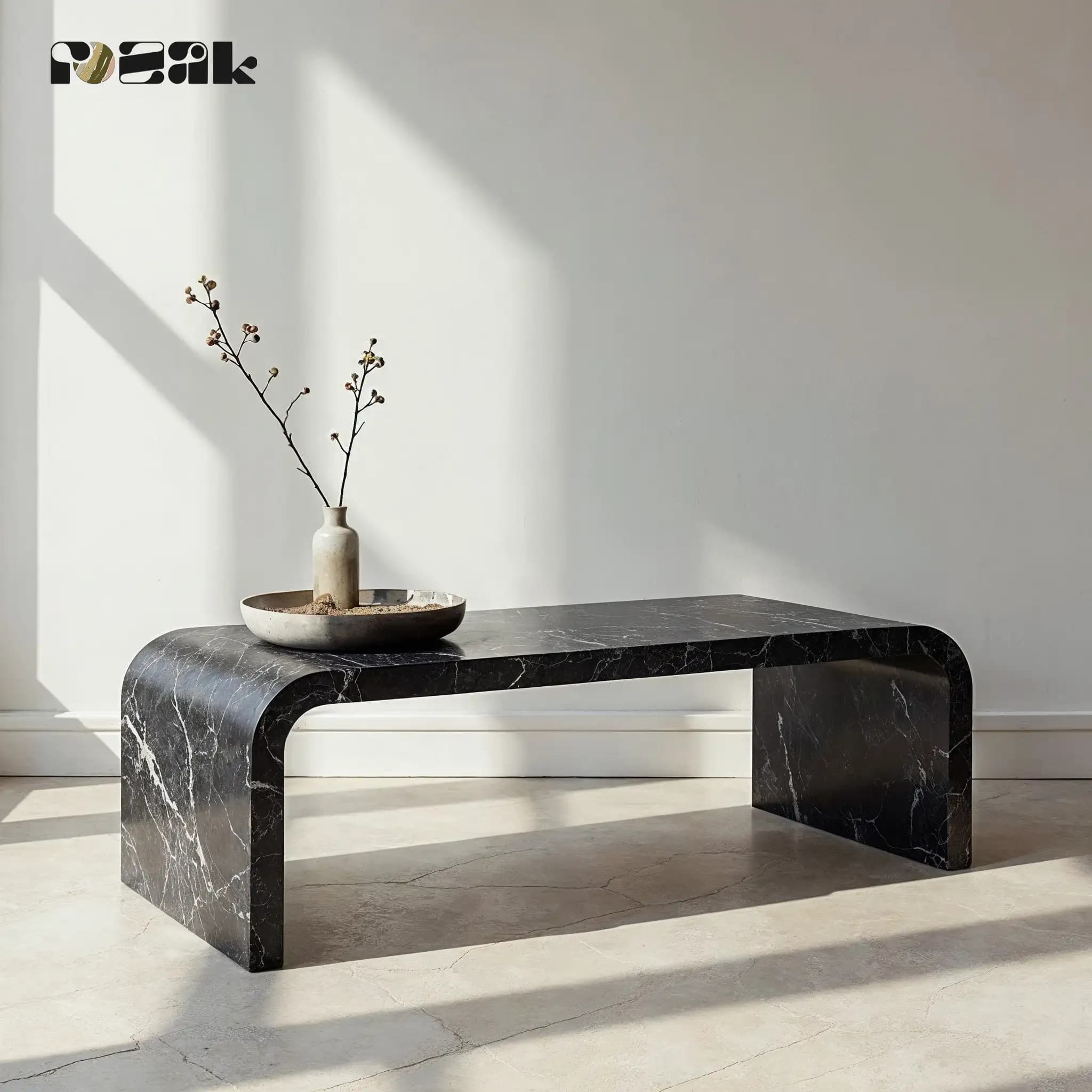 A waterfall-edge coffee table in Nero Marquina marble with white veining