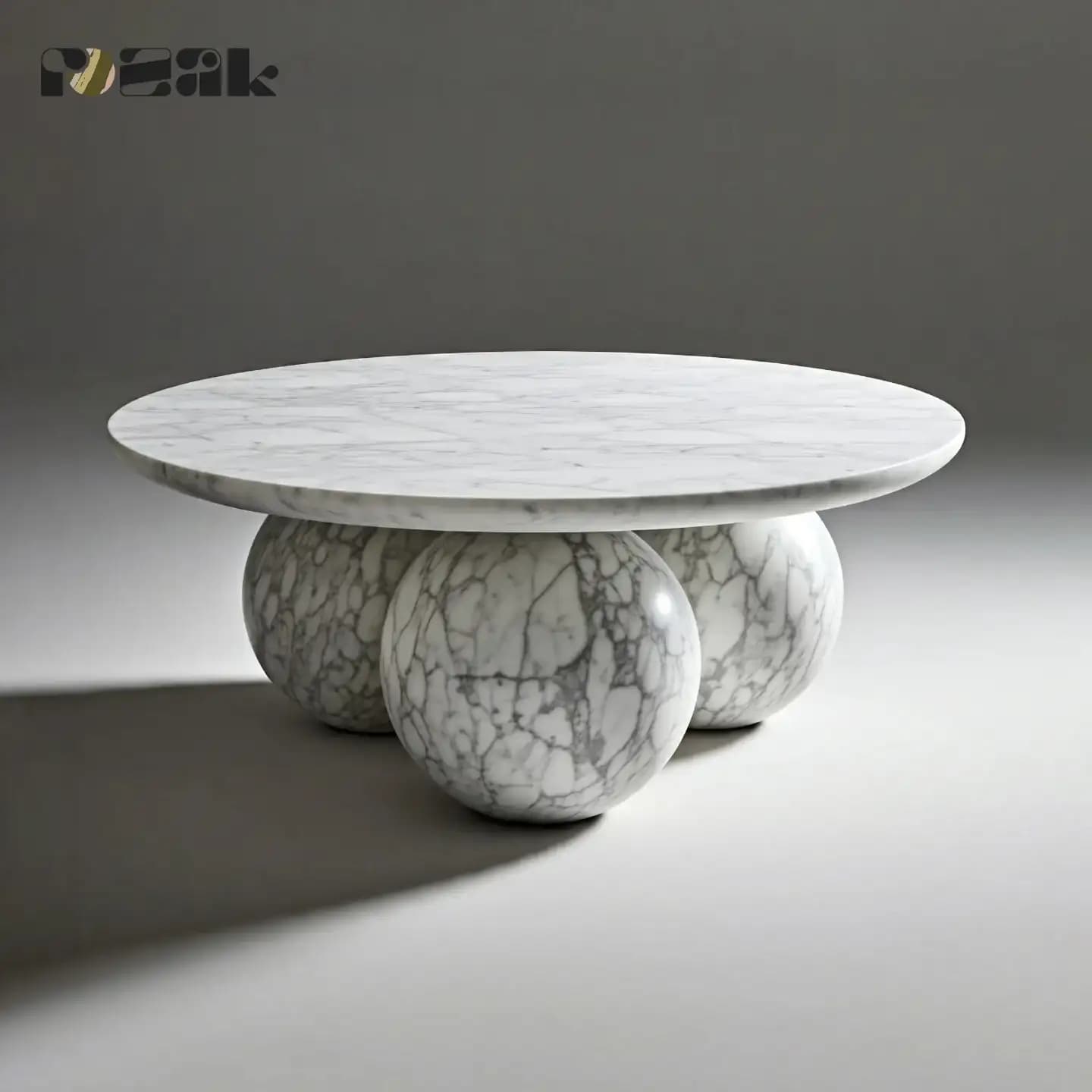 A round Carrara marble coffee table resting on three solid marble spheres
