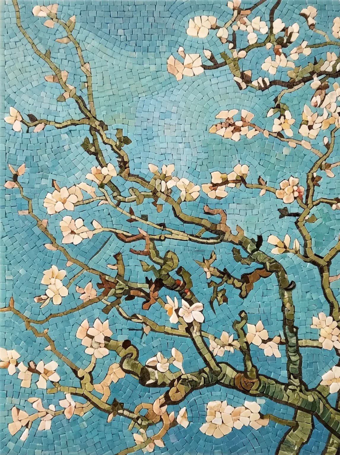 Azuvelle marble mosaic panel with flowering branches and pale blossoms on a blue-green tessellated background